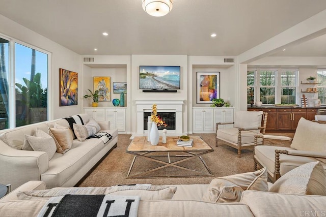 7603 Circulo Sequoia, Carlsbad, CA 92009 - living area with a glass covered fireplace, recessed lighting, healthy amount of natural light, and carpet floors