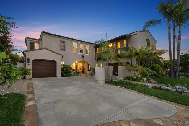 7603 Circulo Sequoia, Carlsbad, CA 92009 - mediterranean / spanish-style home featuring a balcony, concrete driveway, stucco siding, a garage, and a tiled roof