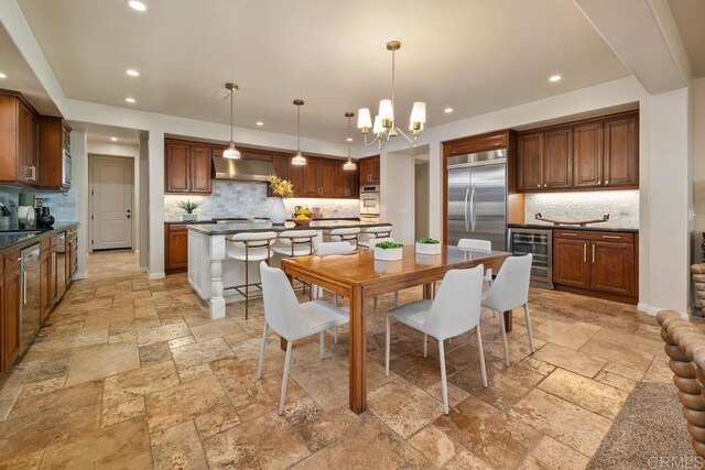 7603 Circulo Sequoia, Carlsbad, CA 92009 - dining room with beverage cooler, stone tile flooring, recessed lighting, and a chandelier