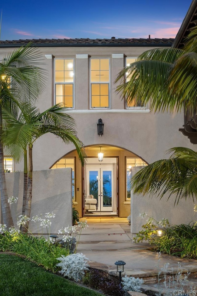 7603 Circulo Sequoia, Carlsbad, CA 92009 - exterior entry at dusk featuring french doors and stucco siding