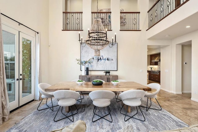7603 Circulo Sequoia, Carlsbad, CA 92009 - dining area featuring a towering ceiling, french doors, a chandelier, and stone finish floors