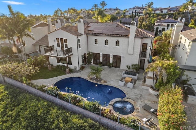 7603 Circulo Sequoia, Carlsbad, CA 92009 - back of house featuring a balcony, a chimney, roof mounted solar panels, and a residential view