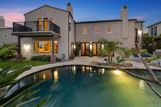 7603 Circulo Sequoia, Carlsbad, CA 92009 - rear view of property with a balcony, a chimney, a patio, stucco siding, and an outdoor pool