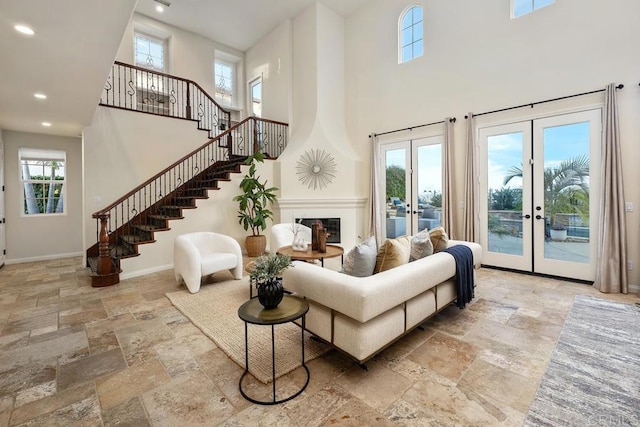 7603 Circulo Sequoia, Carlsbad, CA 92009 - living room featuring a high ceiling, stone tile floors, french doors, stairs, and recessed lighting