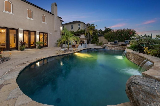 7603 Circulo Sequoia, Carlsbad, CA 92009 - pool at dusk with french doors, an outdoor pool, and a patio area