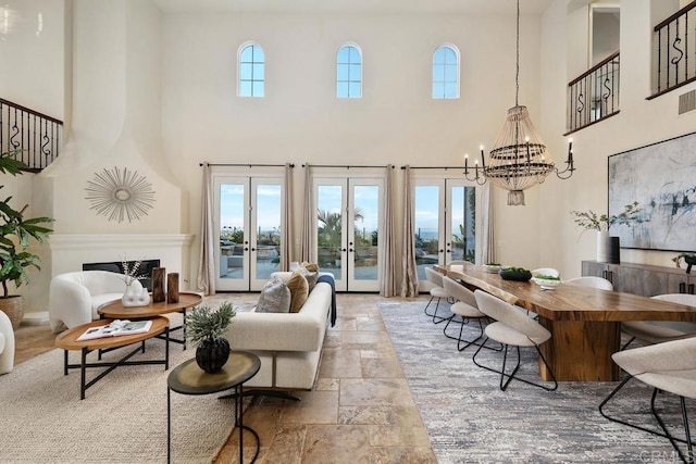 7603 Circulo Sequoia, Carlsbad, CA 92009 - living room with a towering ceiling, french doors, a chandelier, and stone tile flooring