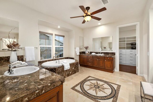 7603 Circulo Sequoia, Carlsbad, CA 92009 - full bath with two vanities, ceiling fan, a garden tub, a walk in closet, and recessed lighting