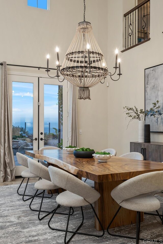 7603 Circulo Sequoia, Carlsbad, CA 92009 - dining space featuring a chandelier, a towering ceiling, wood finished floors, and healthy amount of natural light