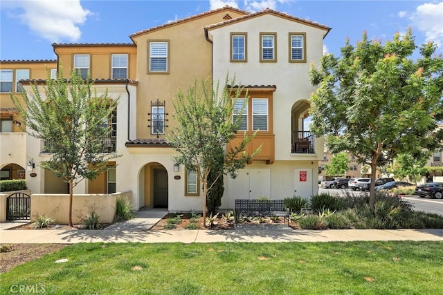 911 Santa Fe Ave Unit A, San Gabriel, CA 91776 - mediterranean / spanish-style home with a tile roof, stucco siding, a gate, a balcony, and a front yard