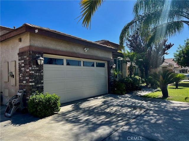 6227 Ocean Jasper Dr, Bakersfield, CA 93313 - view of side of property with driveway, an attached garage, stucco siding, and stone siding