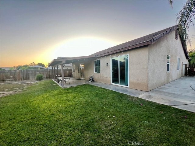 6227 Ocean Jasper Dr, Bakersfield, CA 93313 - back of property featuring a fenced backyard, stucco siding, and a patio area