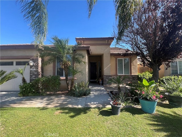 6227 Ocean Jasper Dr, Bakersfield, CA 93313 - view of front of home with stucco siding, brick siding, a front lawn, and an attached garage