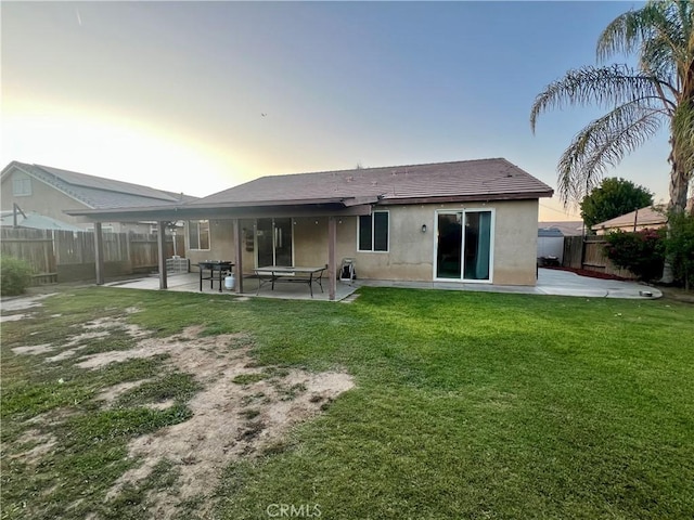 6227 Ocean Jasper Dr, Bakersfield, CA 93313 - rear view of property with stucco siding, a patio area, and a fenced backyard