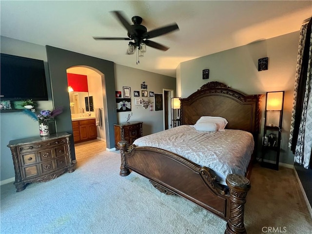 6227 Ocean Jasper Dr, Bakersfield, CA 93313 - bedroom with light carpet, arched walkways, ensuite bath, and ceiling fan
