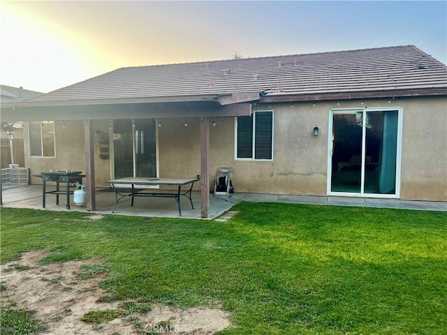 6227 Ocean Jasper Dr, Bakersfield, CA 93313 - back of property featuring stucco siding, a patio area, and a lawn