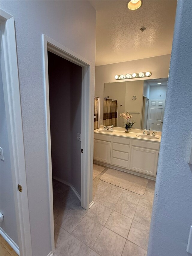 21 Veneto Ln, Aliso Viejo, CA 92656 - full bathroom with double vanity, tile patterned floors, and a textured ceiling