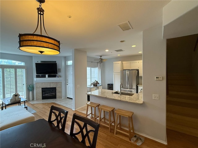 21 Veneto Ln, Aliso Viejo, CA 92656 - dining area with wood finished floors, healthy amount of natural light, a fireplace, ceiling fan, and recessed lighting