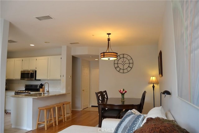 21 Veneto Ln, Aliso Viejo, CA 92656 - dining room with light wood-style floors and recessed lighting