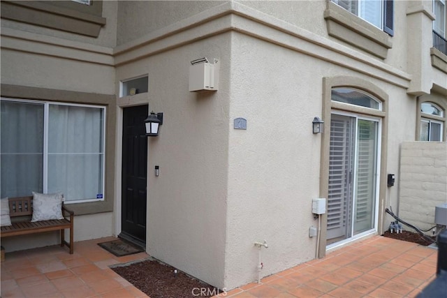 21 Veneto Ln, Aliso Viejo, CA 92656 - doorway to property featuring stucco siding and a patio