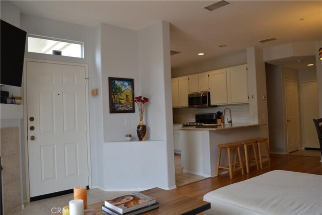 21 Veneto Ln, Aliso Viejo, CA 92656 - foyer entrance with light wood-style floors and recessed lighting