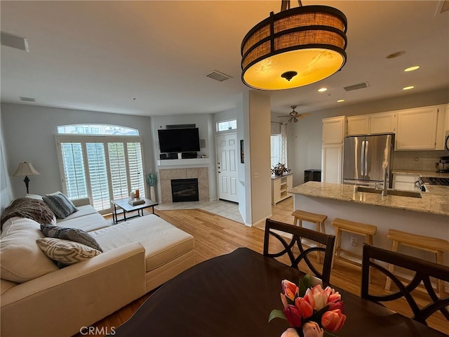 21 Veneto Ln, Aliso Viejo, CA 92656 - living room featuring plenty of natural light, a fireplace, recessed lighting, and light wood-style floors