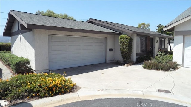 6821 Rocky Grove Ct Unit 13, Yorba Linda, CA 92886 - view of front of house featuring concrete driveway, an attached garage, stucco siding, and a shingled roof