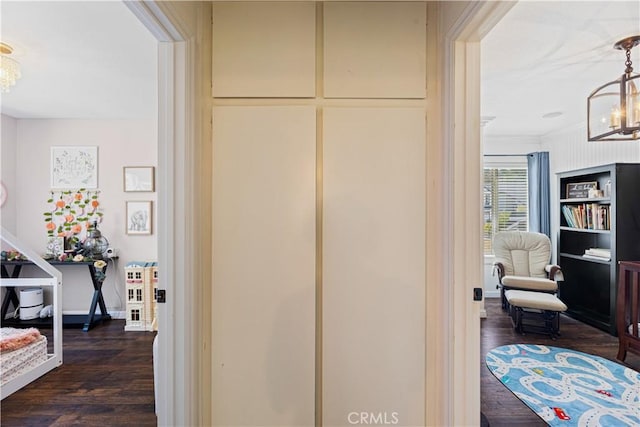 27763 Sequoia Glen Dr, Valencia, CA 91354 - corridor with a chandelier and dark wood-type flooring