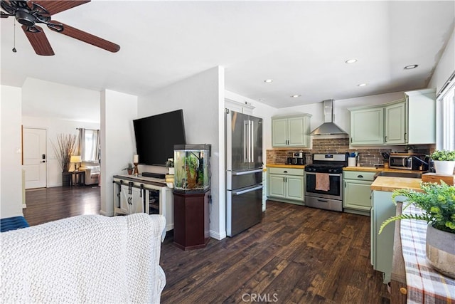 27763 Sequoia Glen Dr, Valencia, CA 91354 - kitchen featuring stainless steel appliances, wall chimney range hood, butcher block countertops, green cabinetry, and dark wood-style floors
