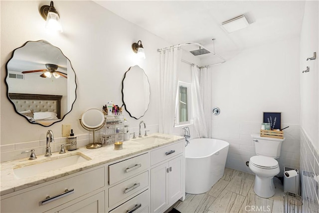27763 Sequoia Glen Dr, Valencia, CA 91354 - full bathroom featuring a freestanding tub, tile walls, double vanity, curtained shower, and a ceiling fan