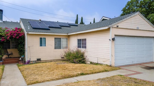 3036 Fairesta St, La Crescenta, CA 91214 - view of front of property with roof mounted solar panels, an attached garage, a shingled roof, and a front lawn