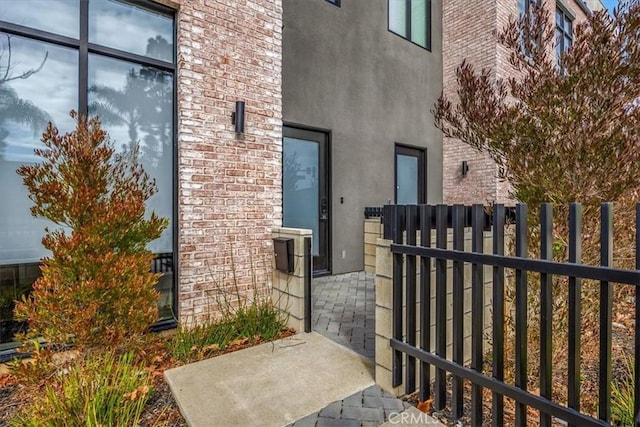756 W 19th St Unit B, Costa Mesa, CA 92627 - view of exterior entry featuring stucco siding, brick siding, and a gate