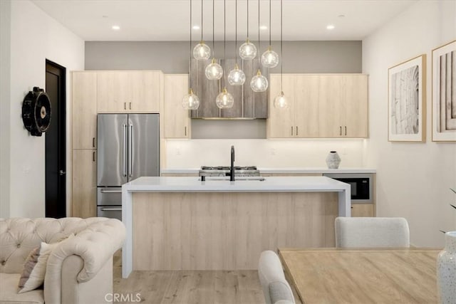 756 W 19th St Unit B, Costa Mesa, CA 92627 - kitchen with high end fridge, light brown cabinetry, light countertops, an island with sink, and modern cabinets