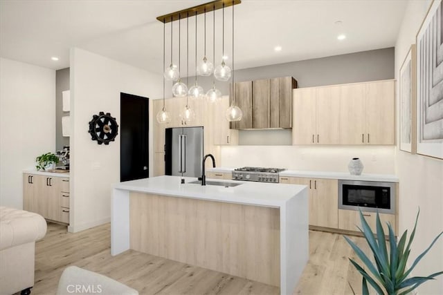 756 W 19th St Unit B, Costa Mesa, CA 92627 - kitchen featuring appliances with stainless steel finishes, light brown cabinets, modern cabinets, light wood-style flooring, and a center island with sink