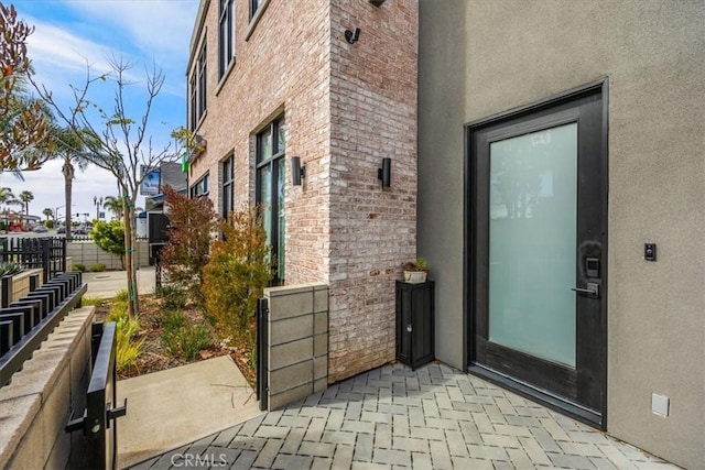 756 W 19th St Unit B, Costa Mesa, CA 92627 - doorway to property with a patio area, stucco siding, and brick siding
