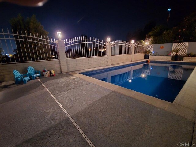 9933 Golden W Ln, Santee, CA 92071 - pool at twilight featuring a patio