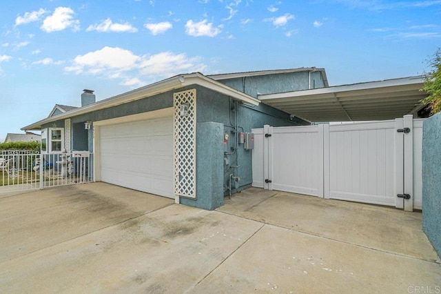 9933 Golden W Ln, Santee, CA 92071 - view of home's exterior with a gate, a garage, driveway, and a chimney
