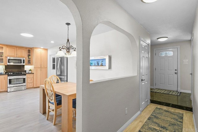 9933 Golden W Ln, Santee, CA 92071 - entrance foyer with arched walkways, light wood finished floors, a chandelier, and recessed lighting