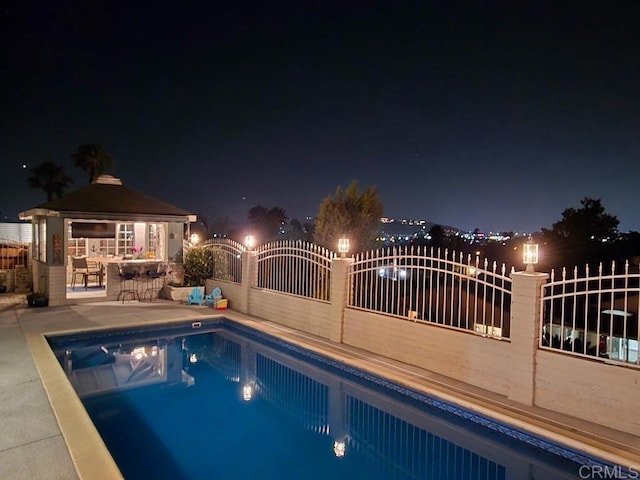 9933 Golden W Ln, Santee, CA 92071 - pool at night featuring an outdoor pool, a patio, and a gazebo