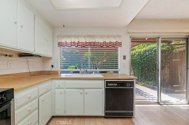 2747 Persimmon Pl, Riverside, CA 92506 - kitchen featuring black dishwasher, light countertops, decorative backsplash, light wood-style floors, and range