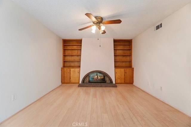 2747 Persimmon Pl, Riverside, CA 92506 - unfurnished living room featuring built in features, a ceiling fan, a brick fireplace, and hardwood / wood-style floors