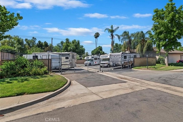 2747 Persimmon Pl, Riverside, CA 92506 - view of asphalt street featuring curbs, a gated entry, and a gate