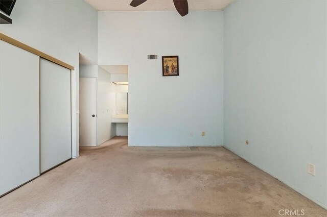 2747 Persimmon Pl, Riverside, CA 92506 - unfurnished bedroom with carpet, connected bathroom, high vaulted ceiling, a closet, and ceiling fan