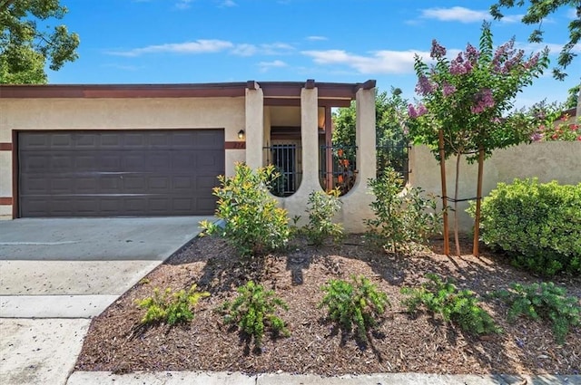 2747 Persimmon Pl, Riverside, CA 92506 - view of front of home with stucco siding, an attached garage, and driveway