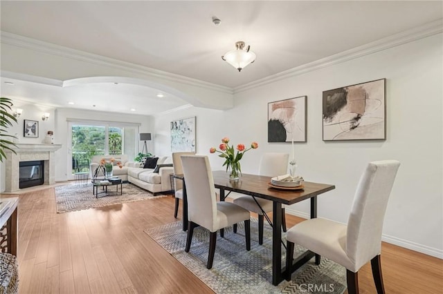 6221 Monterey Rd Unit 402, Los Angeles, CA 90042 - dining room with wood finished floors, a high end fireplace, ornamental molding, arched walkways, and recessed lighting