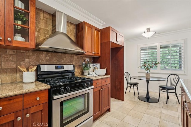 6221 Monterey Rd Unit 402, Los Angeles, CA 90042 - kitchen featuring wall chimney range hood, stainless steel gas stove, crown molding, tasteful backsplash, and light tile patterned floors