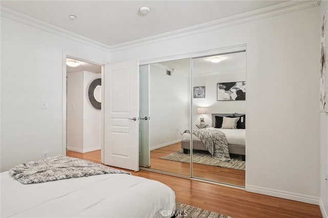 6221 Monterey Rd Unit 402, Los Angeles, CA 90042 - bedroom featuring a closet, crown molding, and wood finished floors