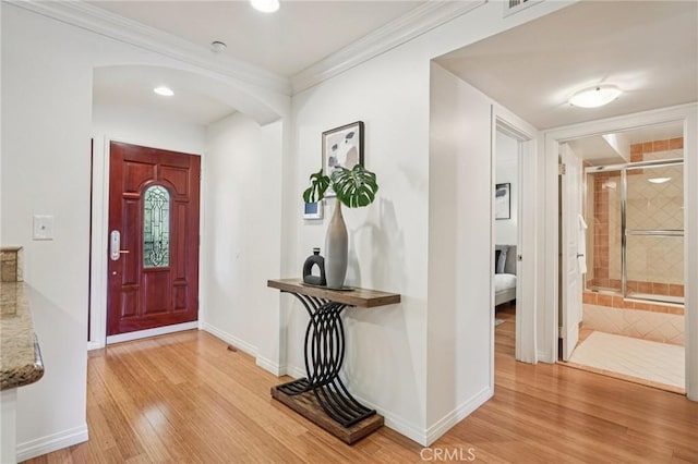 6221 Monterey Rd Unit 402, Los Angeles, CA 90042 - entrance foyer with arched walkways, light wood-style flooring, and crown molding