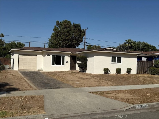 3055 Ronald St, Riverside, CA 92506 - single story home with an attached garage, stucco siding, and asphalt driveway