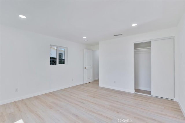 156 N Sunset Ave, Banning, CA 92220 - unfurnished bedroom with recessed lighting, light wood finished floors, and a closet