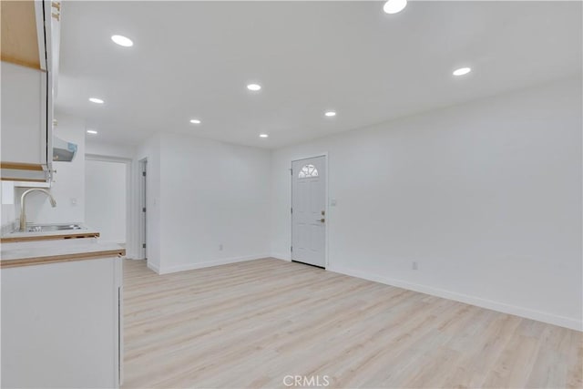 156 N Sunset Ave, Banning, CA 92220 - unfurnished living room with light wood-style floors and recessed lighting